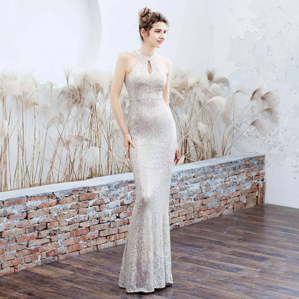 A shimmering white sequin polyester mermaid evening dress with halter neckline and keyhole detail