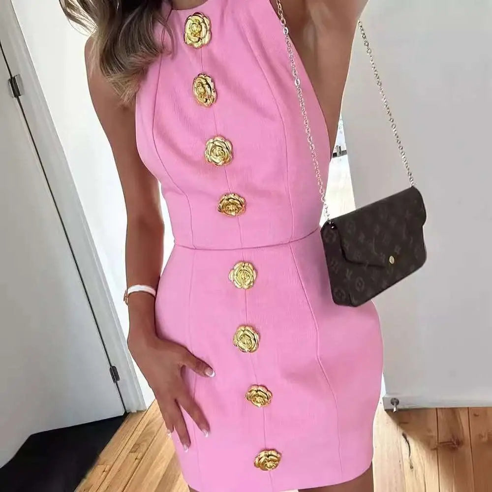 Pink sleeveless backless mini dress with halter neck and gold rose button design down the front