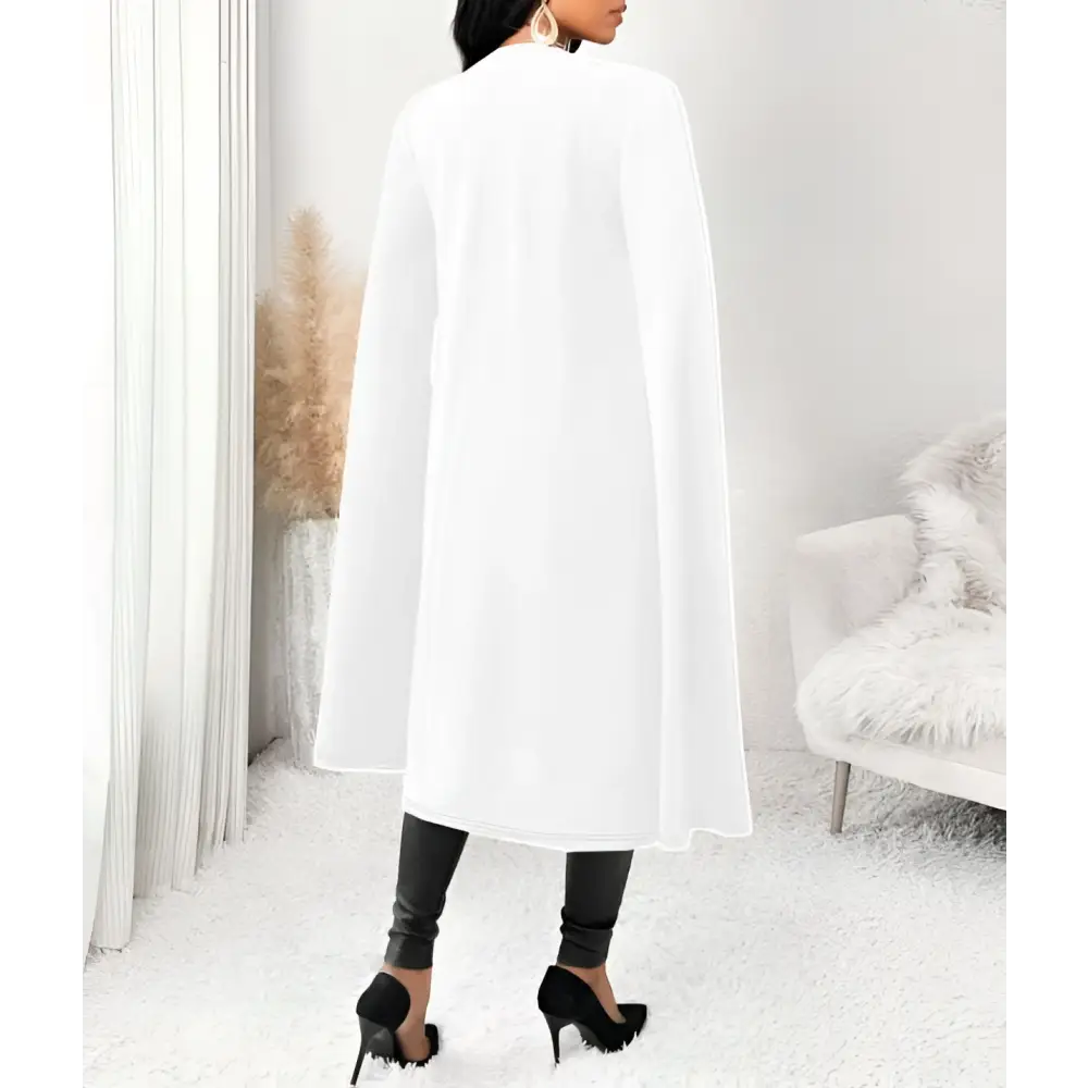 White sleeveless casual fit cape vest with flowing wide sleeves made of soft lightweight fabric for elegant layering
