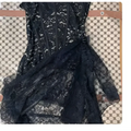 White strapless lace dress with fitted lace corset bodice and flowing skirt featuring white floral lace detailing