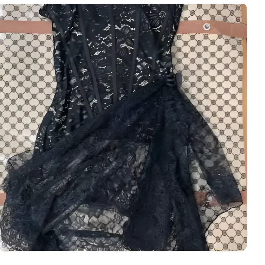 White strapless lace dress with fitted lace corset bodice and flowing skirt featuring white floral lace detailing