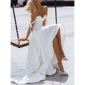 White strapless flowing wedding gown with delicate shoulder ties and a sexy sling high slit for formal occasions