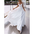 A flowing white satin wedding gown with a sweetheart neckline thin shoulder straps and a sexy sling high slit design