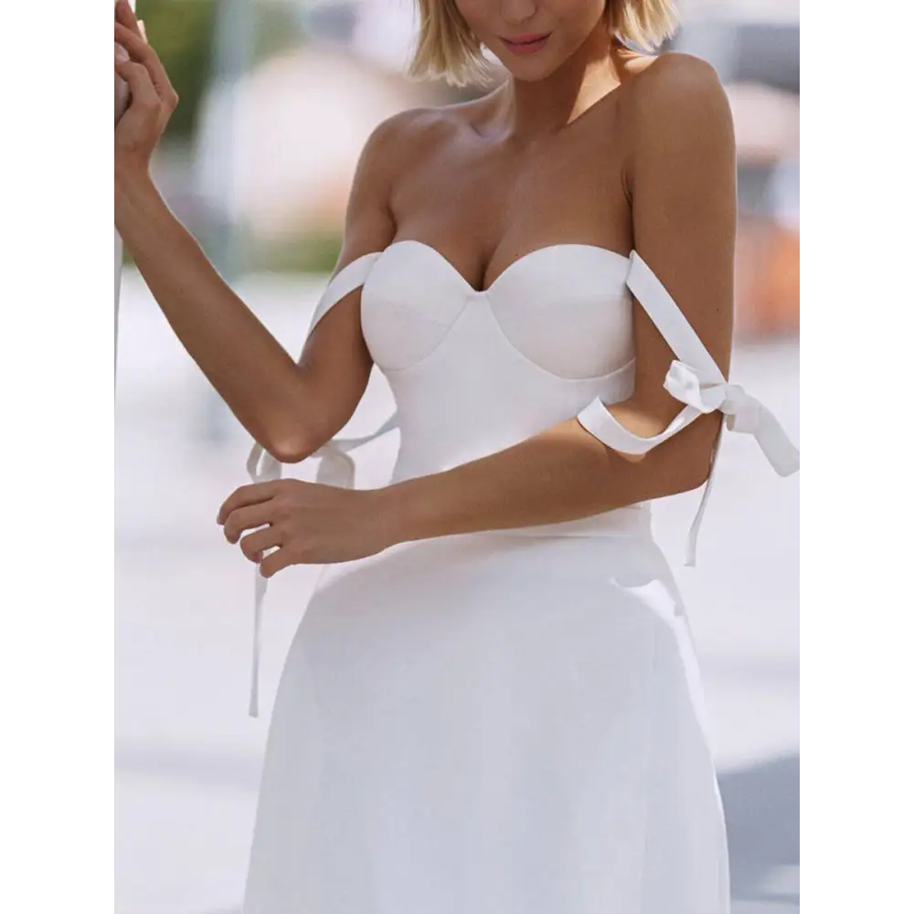 White strapless wedding gown with corset-style bodice tied shoulder straps and sexy sling high slit design