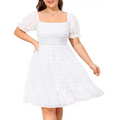 White swiss dot graduation dress with puff sleeves and tiered ruffle hem in a textured white fabric