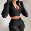 Black textured long-sleeve zip-up crop top and high-waisted leggings set with tummy control and butt lift features