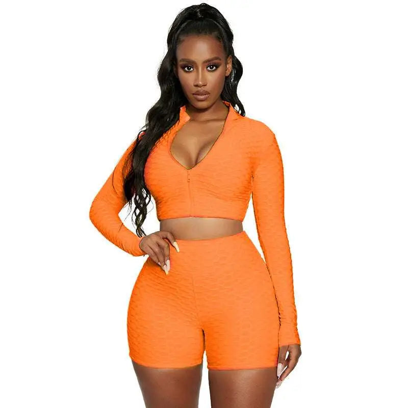 Vibrant orange tummy control two-piece athletic set with textured long-sleeve design for yoga and activewear