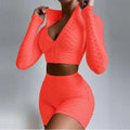 Vibrant orange textured long-sleeve two-piece workout set with tummy control and butt lift high-waisted shorts