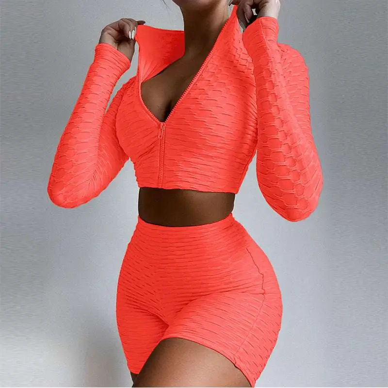 Vibrant orange textured long-sleeve two-piece workout set with tummy control and butt lift high-waisted shorts