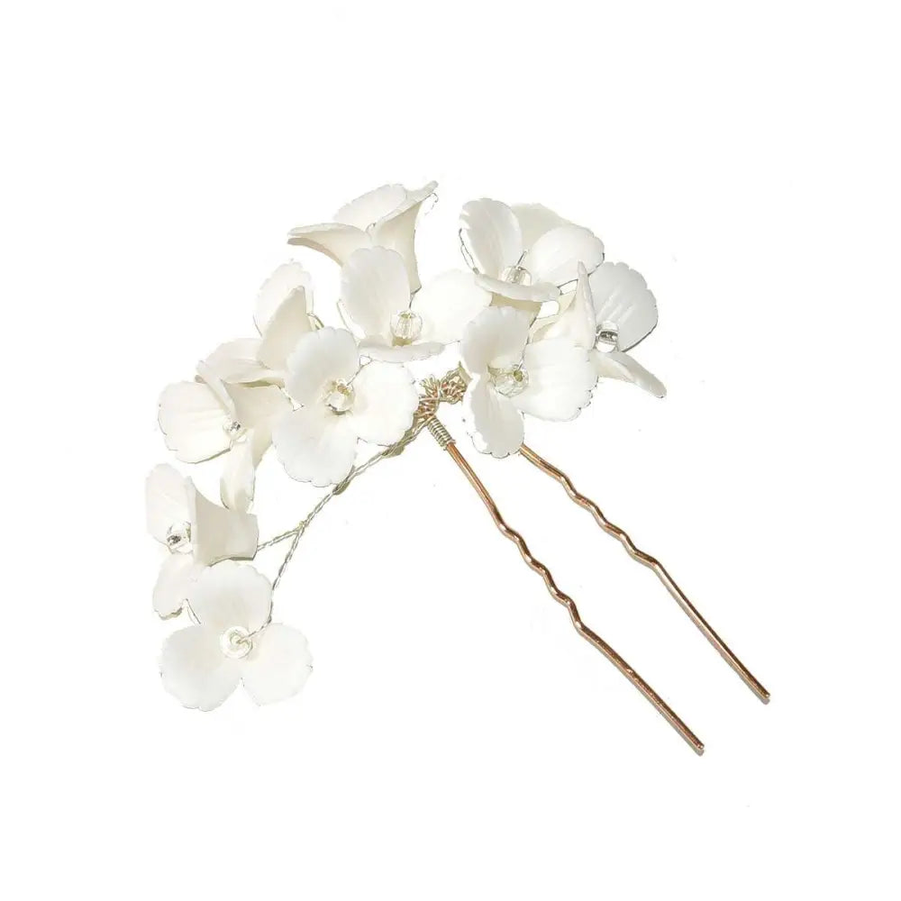 White three dimensional flower u shaped hairpin with delicate white ceramic petals and clear crystal centers on gold base