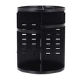 Black cylindrical desk organizer with vertical slotted panels and compartments for eyebrow pencils on multi-layer desktop