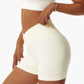 White high-waisted tight seamless sports shorts with ribbed waistband made of seamless fabric for athletic use