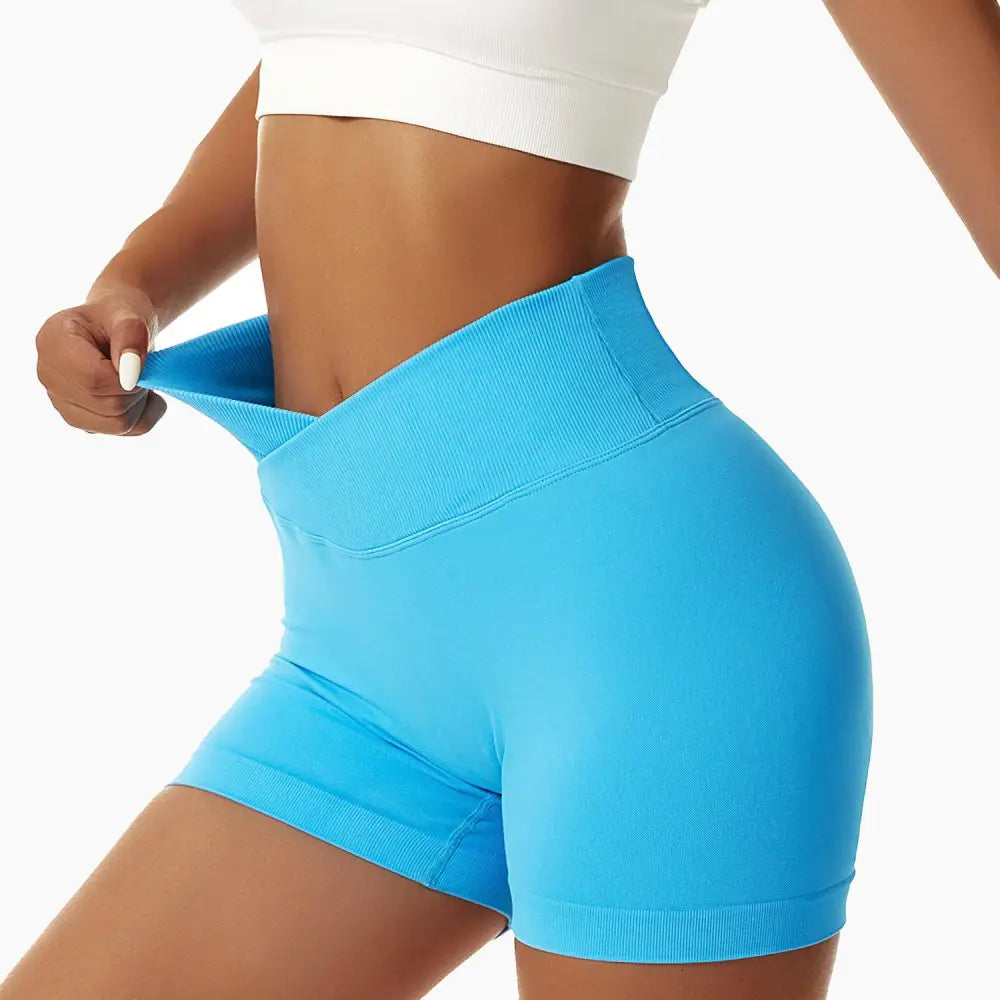 White tight seamless sports shorts in bright blue featuring a high-waisted tight seamless fit with ribbed waistband and leg openings