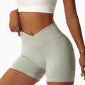Light green high-waisted tight seamless sports shorts with a ribbed waistband and seamless construction