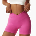 Bright pink high-waisted tight seamless sports shorts with ribbed waistband and seamless construction for activewear