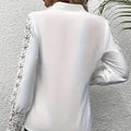 White v neck lace patchwork long sleeved top in white satin with delicate black lace trim on sleeves