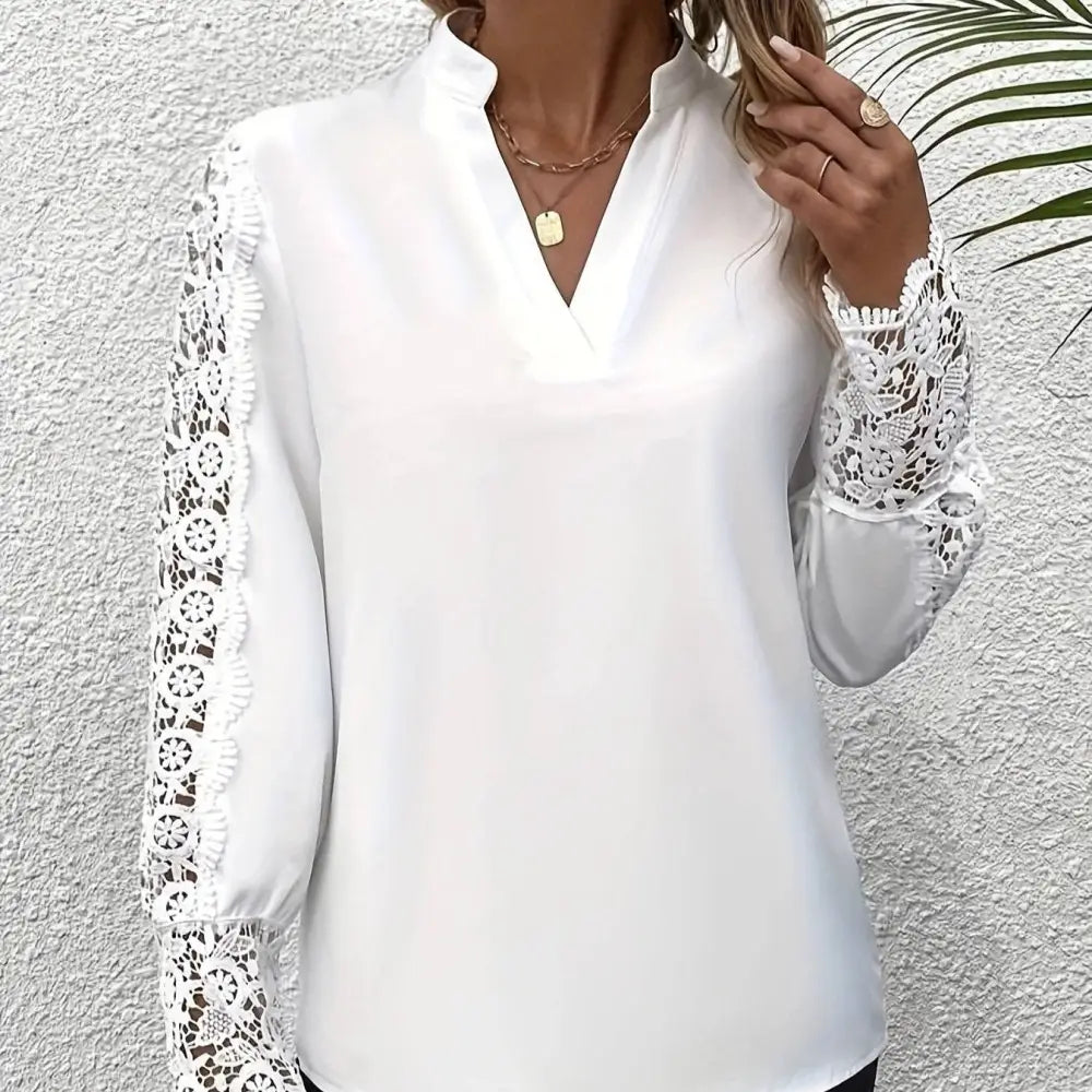White v neck lace patchwork long sleeved top featuring delicate lace trim along the arms and a v neckline