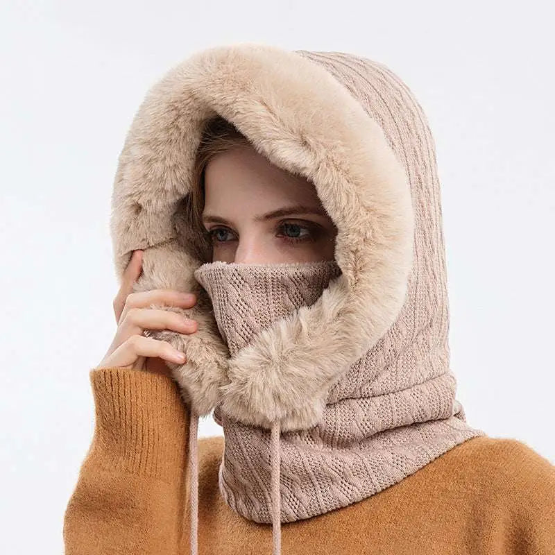 Beige windproof warm knit hooded scarf hat with faux fur trim and matching pom-pom for cold weather</assistant