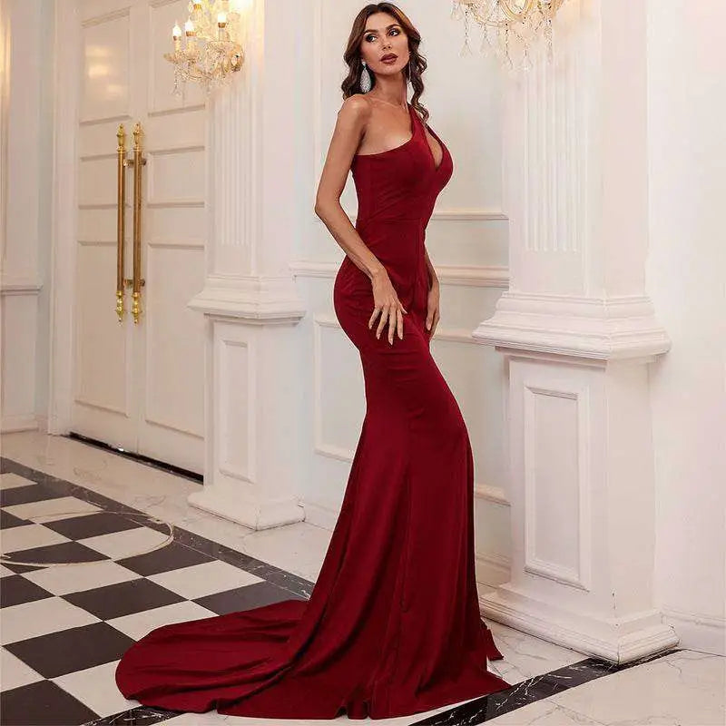Wine red one shoulder solid color mermaid annual meeting dress with halter neckline and long train in form-fitting fabric