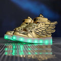 Golden high-top light shoes with winged design and glowing green led soles for charging light shoes use