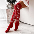 Red knitted christmas thigh-high stockings with white reindeer and snowflake patterns for winter christmas warm dress