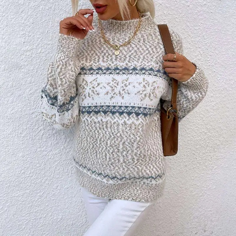 A heathered gray knit winter snowflake sweater with festive white pattern and half turtleneck design