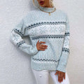 Cozy light blue and white knit winter snowflake sweater with half turtleneck design and dark gray geometric patterns