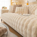 Cream-colored winter thickened rabbit plush faux fur sofa cover with ribbed texture and soft fluffy appearance