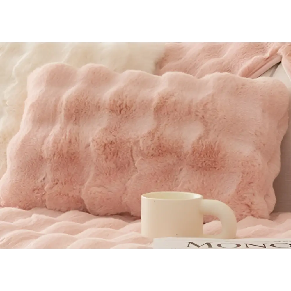 A soft pink winter thickened rabbit plush sofa cushion with thickened faux fur and a wavy textured surface