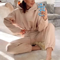 Beige winter two piece sets women tracksuit featuring a cropped hoodie and matching jogger pants for casual wear
