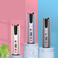Three wireless rechargeable curling irons with cylindrical design in rose gold silver and gunmetal finishes with digital display