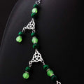 A witchcraft irish knot pagan headpiece with dark green and lime beads separated by silver celtic knot charms