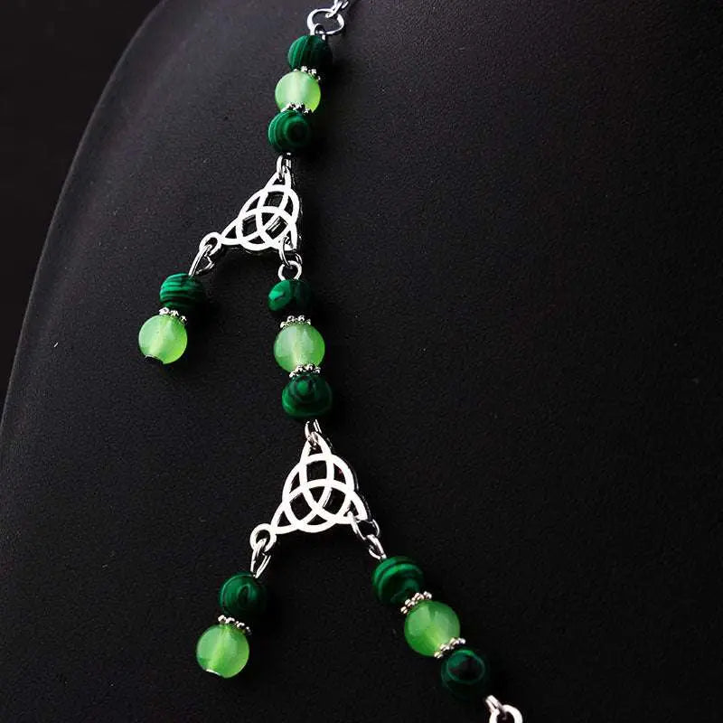 A witchcraft irish knot pagan headpiece with dark green and lime beads separated by silver celtic knot charms