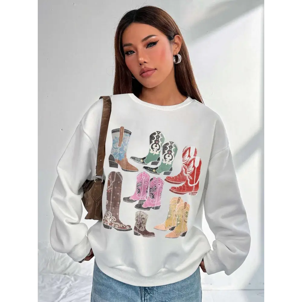 White oversized round neck pullover featuring a colorful women cowboy boots print in various styles and hues
