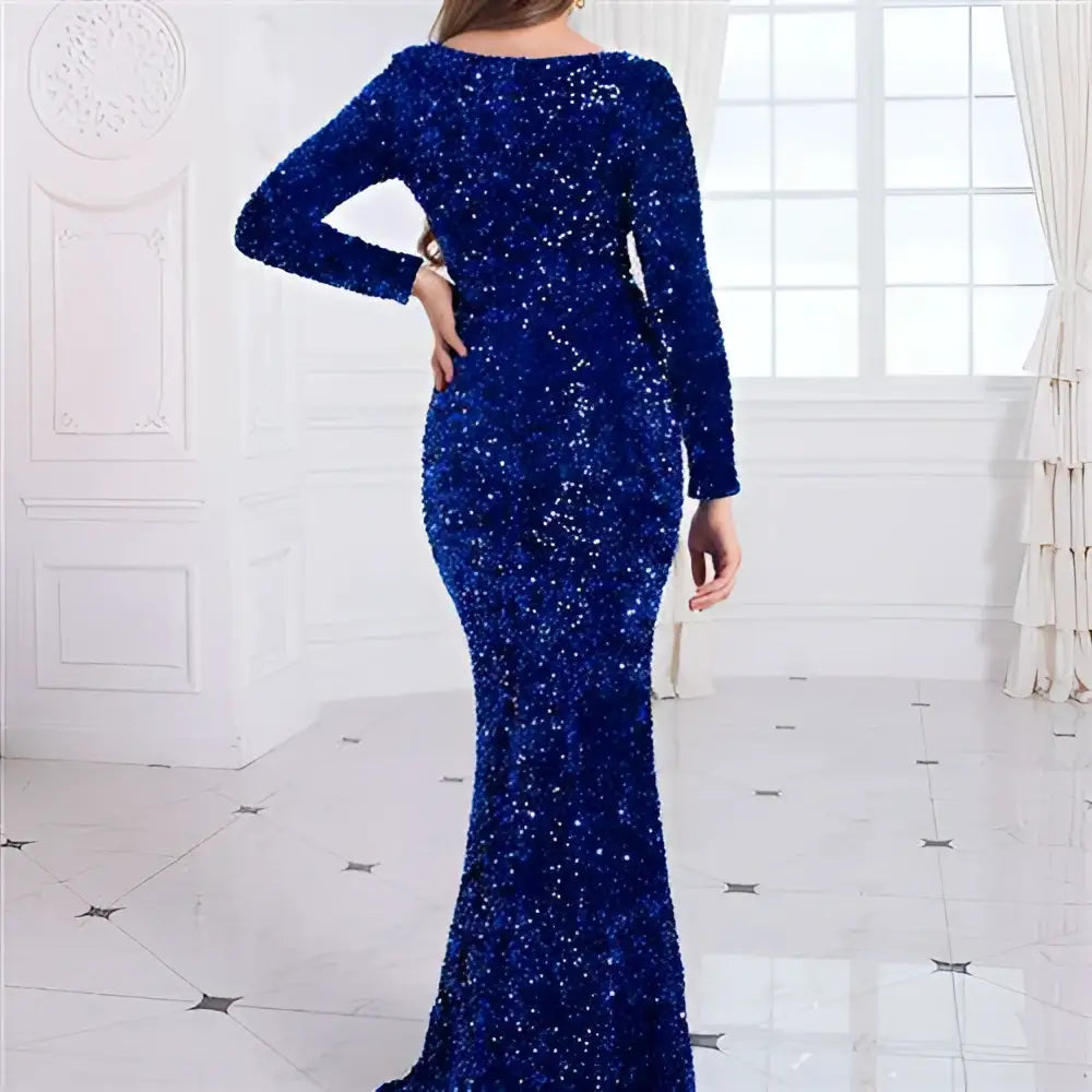 A dazzling royal blue modest stretch sequin evening gown with long sleeves and a fitted silhouette