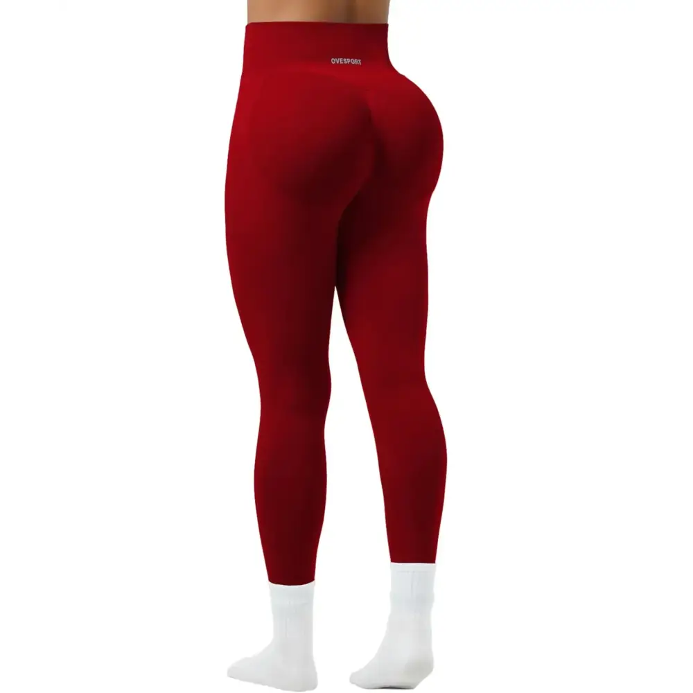 Women seamless high waist yoga pants in red with a snug fit paired with white socks for activewear use