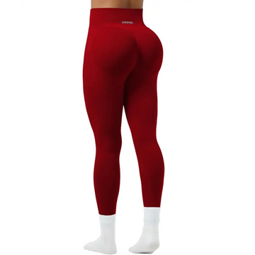 Women seamless high waist yoga pants in red with a snug fit paired with white socks for activewear use