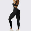 Back view of black sleeveless flare jumpsuit with cutout details designed for flare fitness yoga and high-waisted leggings