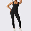 Black sleeveless flare jumpsuit with thin straps and fitted silhouette for flare fitness yoga and high-waisted flared leggings look