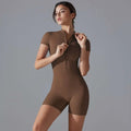A sleek taupe shorts jumpsuit yoga bodysuit with short sleeves and a zipper designed front for summer workouts