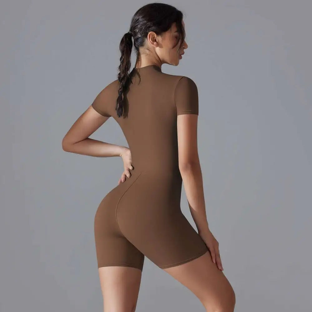 A sleek brown shorts jumpsuit yoga bodysuit with short sleeves high neckline and zipper designed for summer use