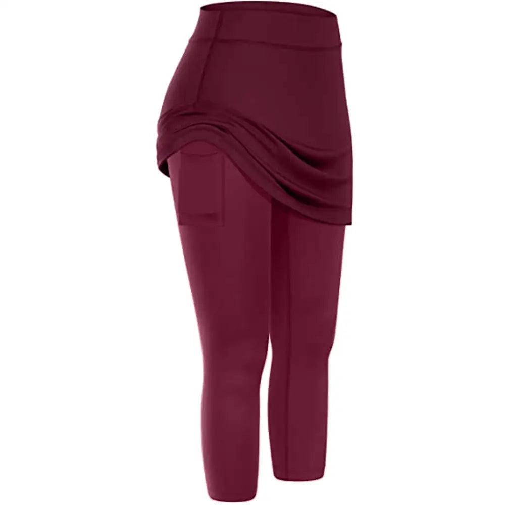 Black women tennis skirted leggings featuring a draped skirt overlay and side phone pocket for activewear use