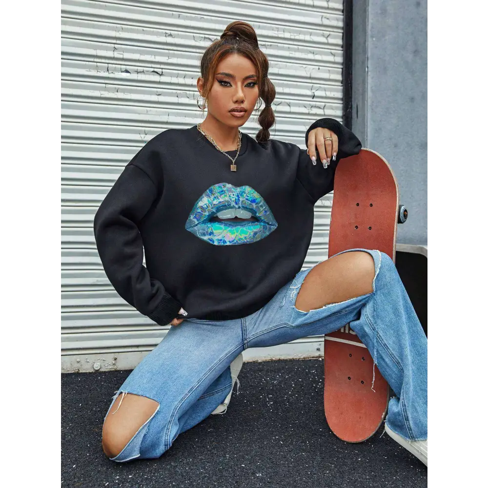 Black women’s blue lips graphic long sleeve sweatshirt with vibrant blue and teal watercolor-style lip print