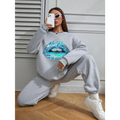 Gray women’s long sleeve sweatshirt featuring a vibrant blue lips graphic on the front in teal and blue tones
