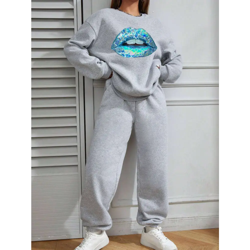 Women’s long sleeve sweatshirt in gray featuring a large vibrant blue lips graphic on the front
