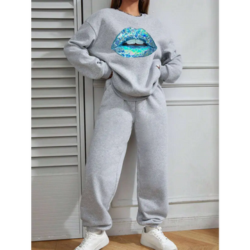 Women’s long sleeve sweatshirt in gray featuring a large vibrant blue lips graphic on the front