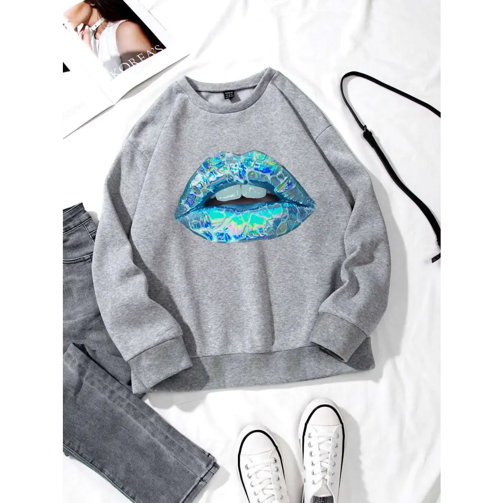 Gray women’s long sleeve sweatshirt featuring a vibrant blue lips graphic in iridescent blue and teal colors