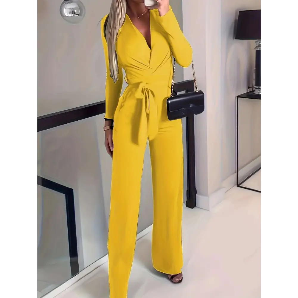 Bright yellow long-sleeved wrap jumpsuit with belted waist and wide-leg pants for a casual sleeveless jumpsuit look