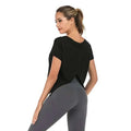 Black short-sleeved athletic top with relaxed fit and back cutout detail shown from the back side