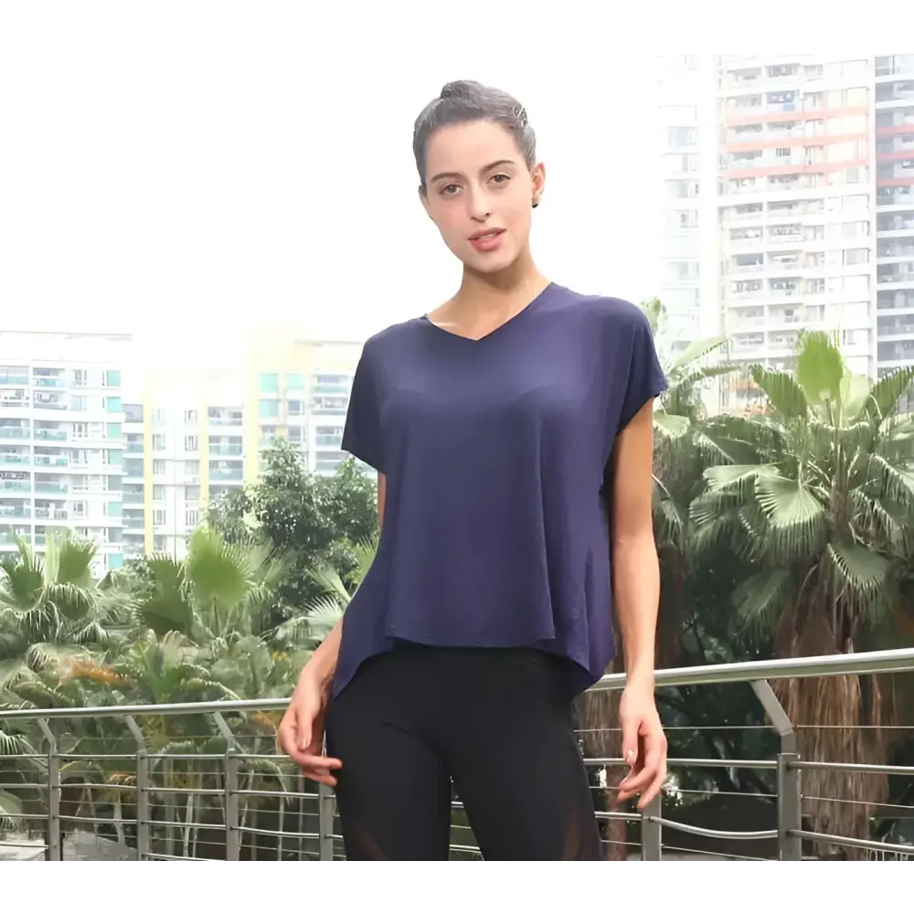 A navy blue loose-fitting v-neck sports t-shirt with short sleeves and asymmetrical hemline for women